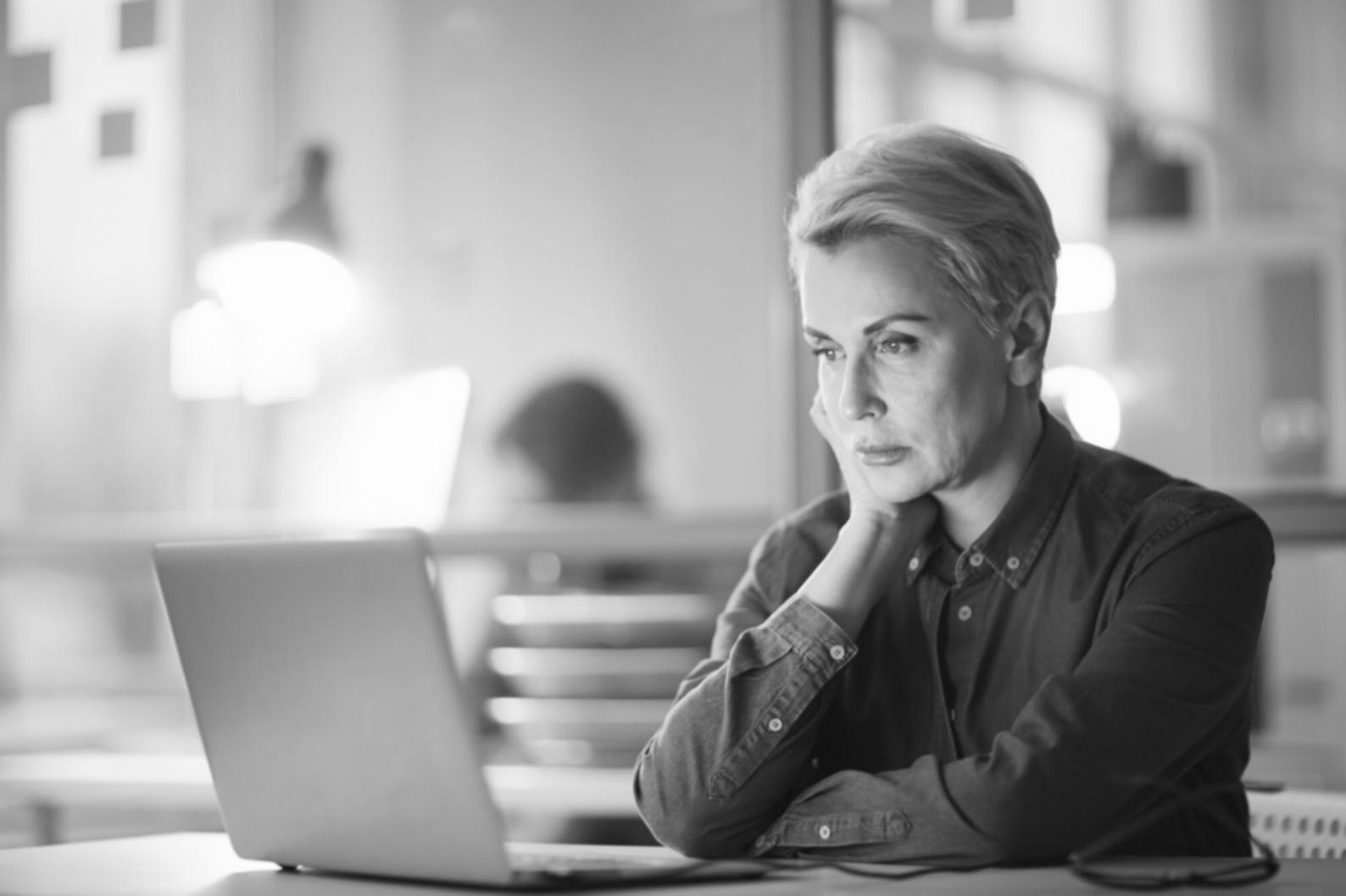 Student analyzing color relationships on multiple screens showing various web design projects